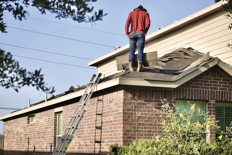Professional roofer working on a residential roof in Accotink